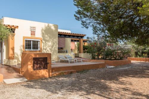 a house with a fire place in front of it at Ca Sa Vilda in Es Pujols