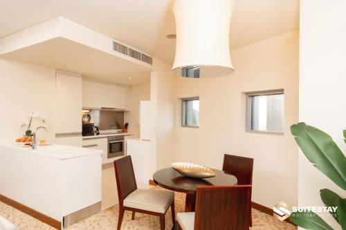 a kitchen and dining room with a table and chairs at Fashion avenue Dubai Mall -The Residence in Dubai