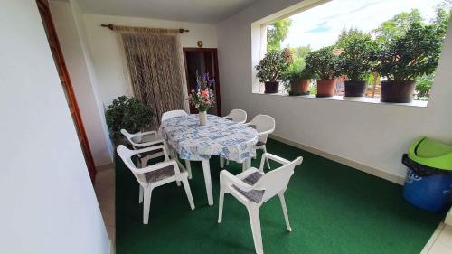 a table and chairs in a room with green carpet at Apartment Siofok, Somogy 7 in Siófok