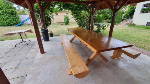 a wooden bench sitting under a gazebo at Apartment Siofok, Somogy 7 in Siófok