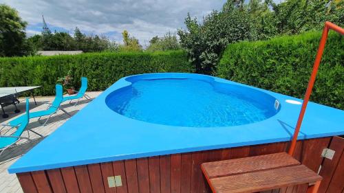 a hot tub in a backyard with a table and chairs at Apartment Siofok, Somogy 7 in Siófok