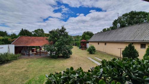 a large yard with a building and a pavilion at Apartment Siofok, Somogy 7 in Siófok