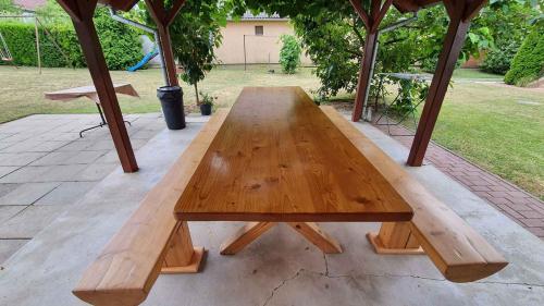 a wooden picnic table sitting under a gazebo at Apartment Siofok, Somogy 7 in Siófok