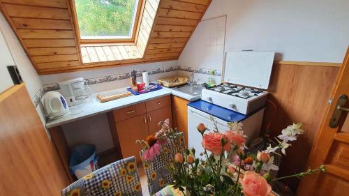 a small kitchen with a stove and a sink at Apartment Siofok, Somogy 7 in Siófok