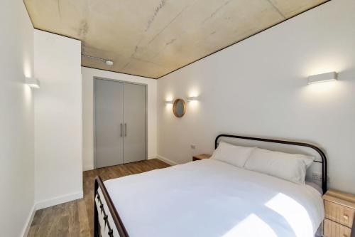 a bedroom with a white bed in a room at Repton Gardens at Wembley Park in London