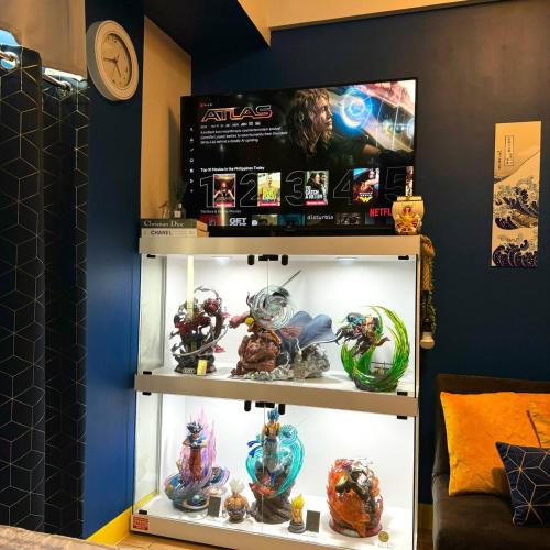 a display case with marvel figurines in a room at Casas Reales Staycation & Rentals in Biñan