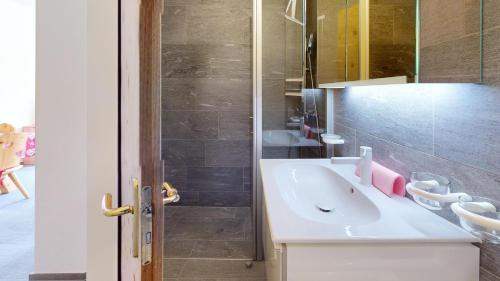a bathroom with a white sink and a shower at Abitaziun Haus Westend 7A - St Moritz in St. Moritz