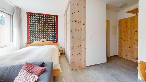 a bedroom with a bed and a wooden wall at Abitaziun Haus Westend 7A - St Moritz in St. Moritz