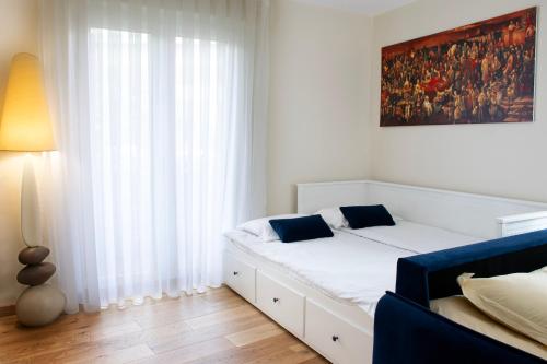 a bedroom with a white bed and a large window at New Flat near Paris with Secure Parking 7' to RER B direct line CDG ORY in Le Plessis-Robinson