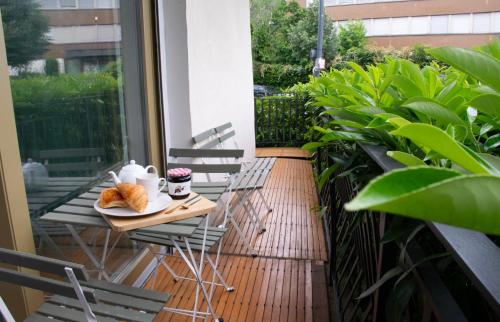 a table with a plate of croissants on a balcony at New Flat near Paris with Secure Parking 7' to RER B direct line CDG ORY in Le Plessis-Robinson