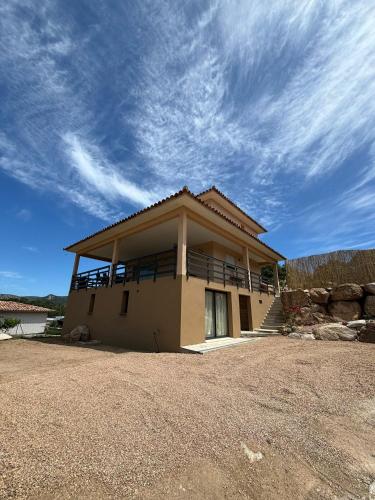 a house with a balcony on top of it at ISULA PETRA in Porto-Vecchio