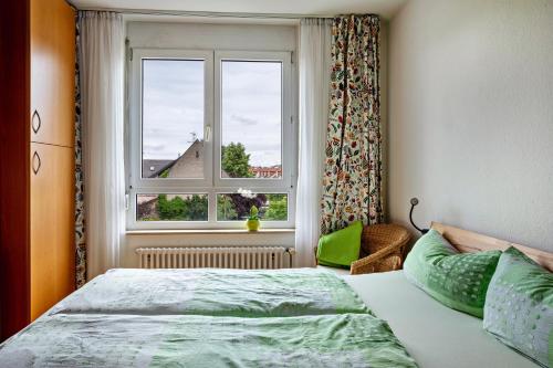 a bedroom with a bed and a window at Meienreis in Breisach am Rhein