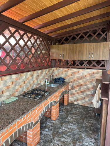 an outdoor kitchen with a stove in a brick wall at Casa Tudor in Tîrgu Ocna