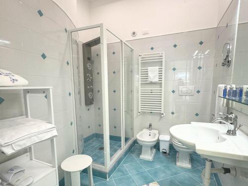 a bathroom with a shower and a toilet and a sink at Villa Fiorentino in Positano