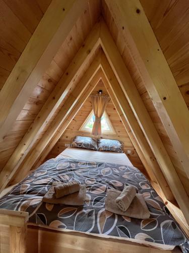 a bed in the middle of a attic at Cottage Danilo in Žabljak