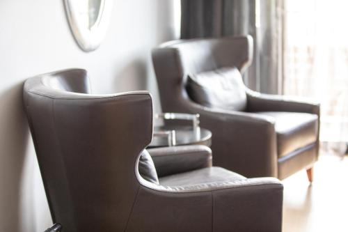 two leather chairs sitting next to a window at Quality Hotel Ulstein in Ulsteinvik