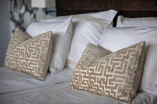 a white bed with white pillows on it at Quality Hotel Ulstein in Ulsteinvik