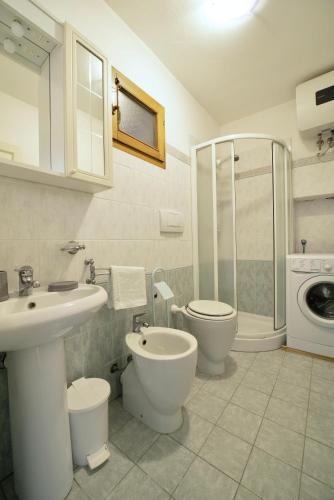 a bathroom with a sink and a toilet and a shower at Perfume House in Marciana