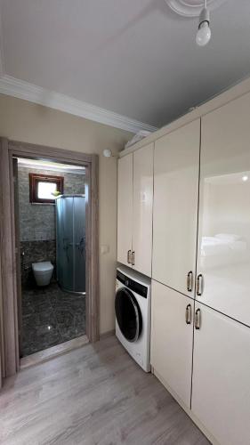 a laundry room with a washer and dryer at Kaya Palace in Uzungöl
