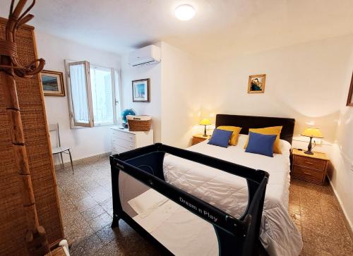 a bedroom with a bed with blue pillows on it at La casina di Marco in Marina di Pietrasanta