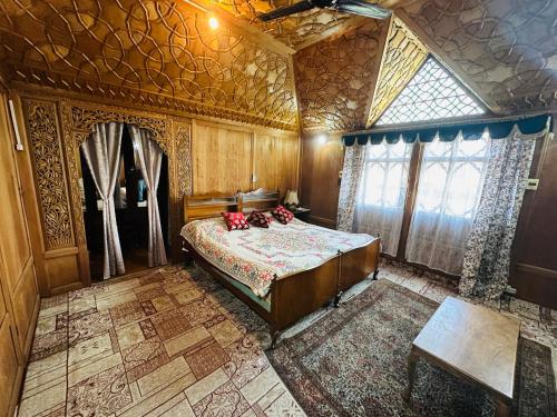 a bedroom with a bed in a room with a ceiling at Maharaja palace houseboat in Srinagar