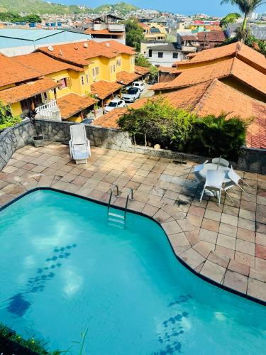 a swimming pool with a view of a city at Casa na praia in Arraial do Cabo