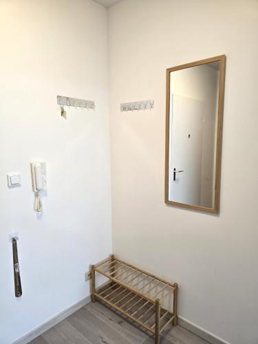 a mirror on a wall with a shelf in a room at City View in Offenbach
