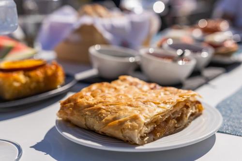 a piece of pie on a plate on a table at Naxos Cave Suites in Stelida