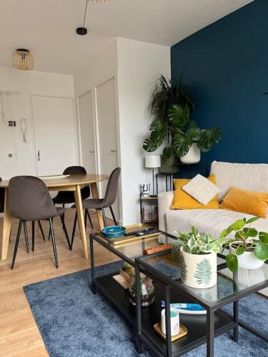 un salon avec un canapé et une table dans l'établissement Paisible T2, à Villeurbanne