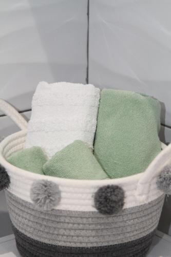 a basket filled with different colored towels at Apartman Hakuna Matata in Rijeka