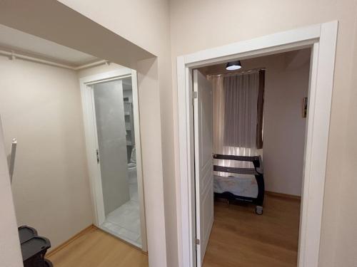 a hallway with a door to a room with a mirror at Kuzguncuk View in Istanbul
