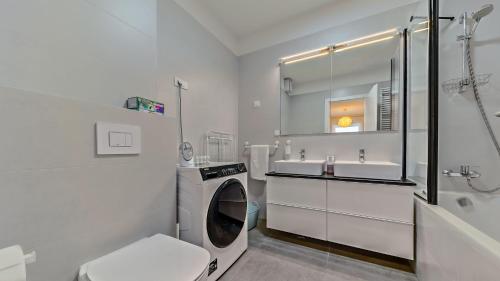 biała łazienka z pralką i umywalką w obiekcie Good Vibes w Zagrzebiu