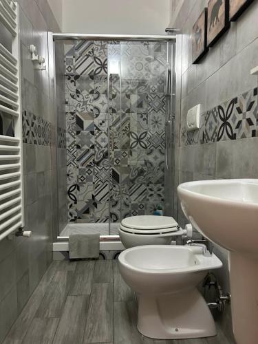 a bathroom with a toilet and a sink and a shower at AM's Apartment in La Spezia