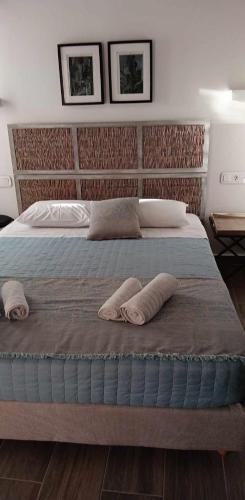 a bedroom with a large bed with two pillows on it at Loggia Traditional Suites in Rethymno Town