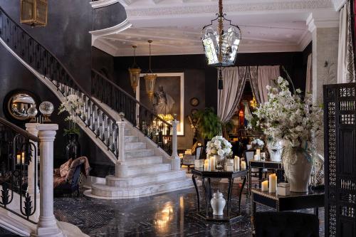a staircase in a room with flowers and candles at Palais Ronsard Relais & Chateaux in Marrakech