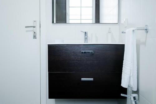 a bathroom with a sink and a mirror at Avenida House 1 in Ponta Delgada