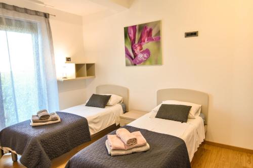 a room with two beds with towels on them at Luxury apartment Vela with swimming pool in Premantura