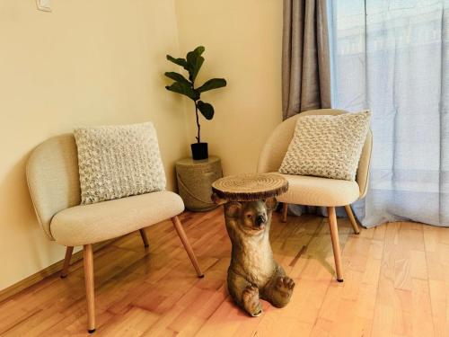 a dog sitting next to two chairs and a table at SP Duna in Budapest