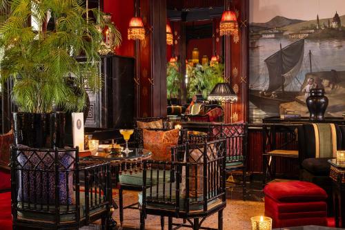 a room with a table and chairs and a painting at Palais Ronsard Relais & Chateaux in Marrakech