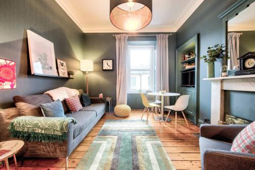 a living room with a couch and a table at GuestReady - Stylish 2BR in Heart of Tollcross in Edinburgh