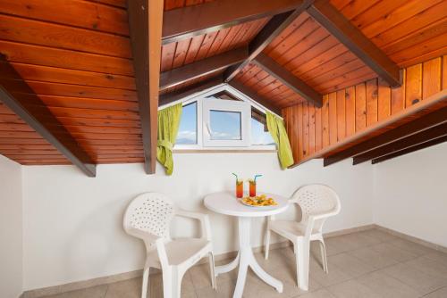 a dining room with a white table and chairs at Safak Oasis Hotel in Dalyan