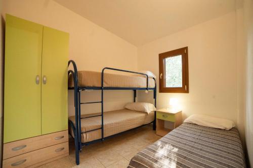 A bed or beds in a room at Holiday Apartment orchidea with swimming pool and private beach -3