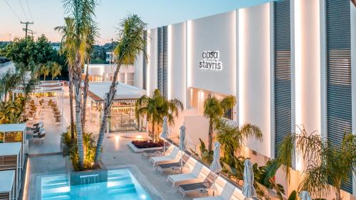an overhead view of a hotel with a pool and palm trees at Casa Stavris in Faliraki