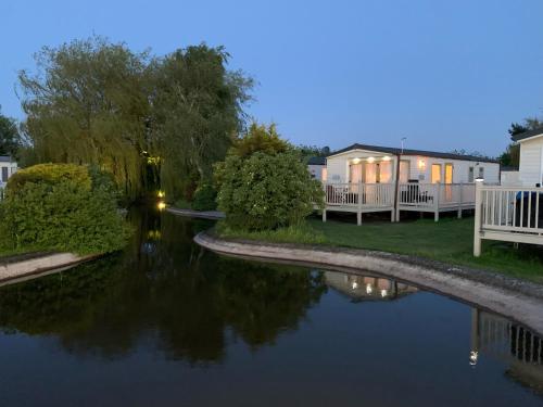 a view of a river at night with houses at 29 Morningside at Southview in Skegness - Park Dean resorts in Lincolnshire