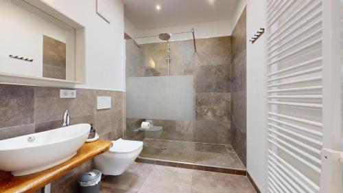 a bathroom with a sink and a toilet and a shower at Apartment Senftenberg - 1907 in Senftenberg