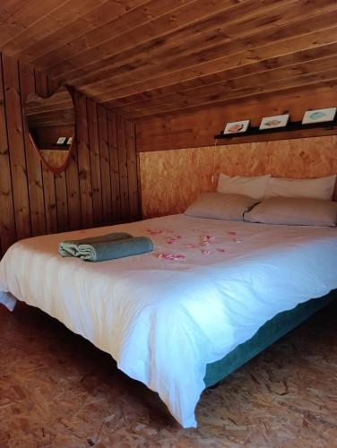 a bedroom with a bed in a wooden room at la caseta viva in Olvan