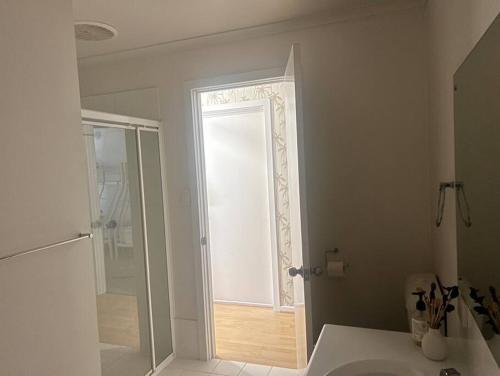 a bathroom with a sink and a mirror and a shower at Ela meine 'Come stay' in Port Moonta
