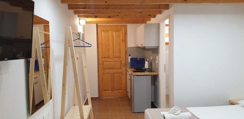 a kitchen with a wooden door in a room at Apart-Hotel Llazari in Himare