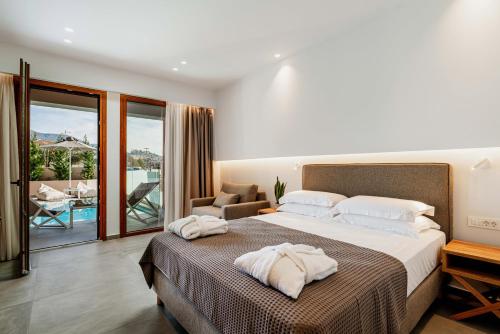 a bedroom with a large bed with towels on it at Aria Luxury Residence in Syvota