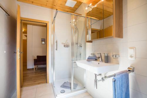 a bathroom with a sink and a shower at Berghaus Weber in Oberstdorf